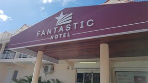 A maroon sign with "FANTASTIC HOTEL" and a star logo. - Fantastic Hotel (Marigot)