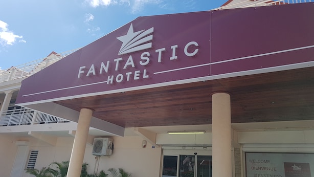 A maroon sign with "FANTASTIC HOTEL" and a star logo. - Fantastic Hotel (Marigot)
