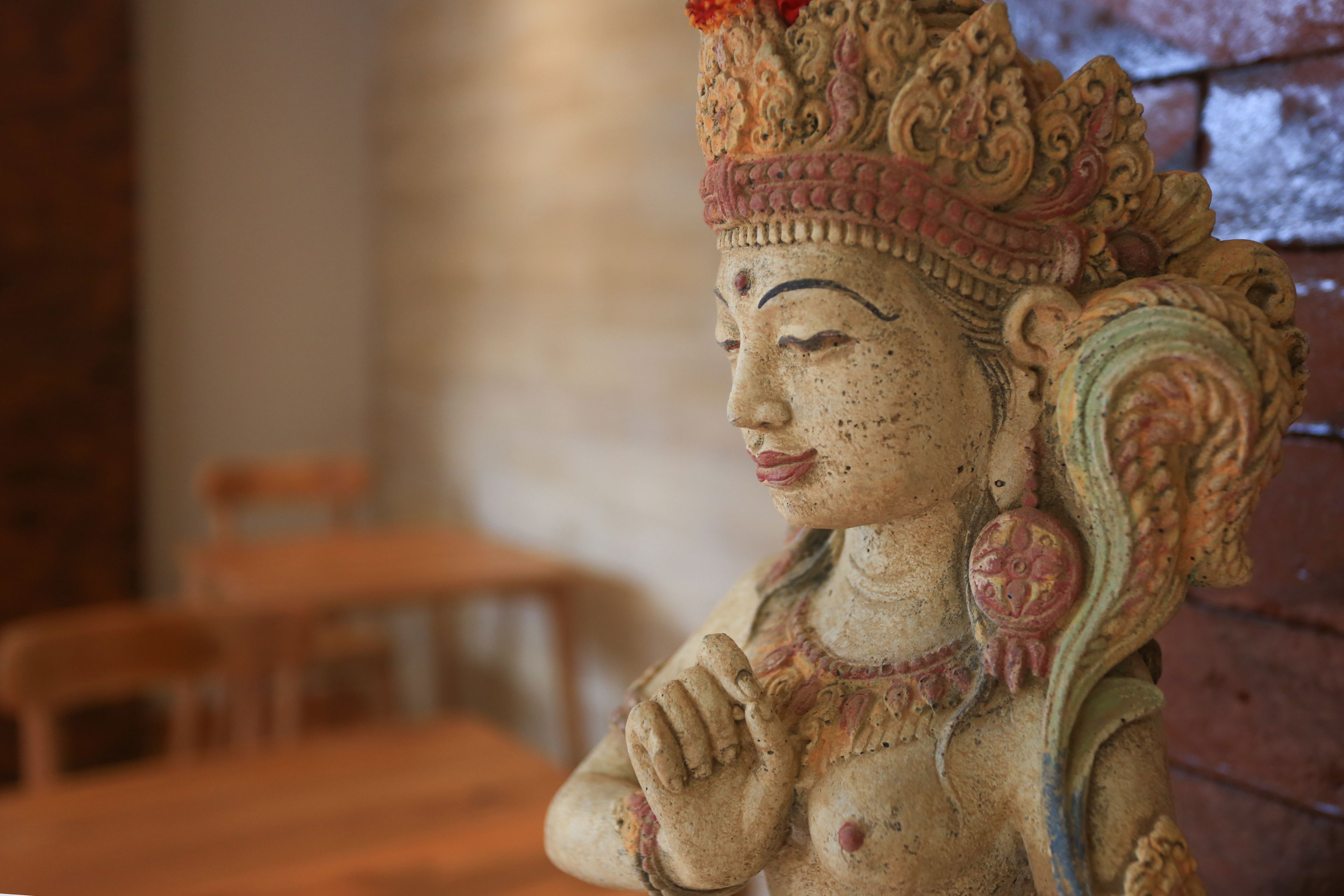 A statue with intricate carvings and a traditional headdress.