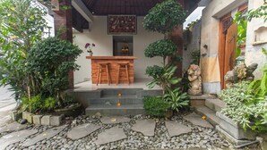 A stone pathway leading to a wooden bench with steps. - Ning Villa Ubud by GenuineHost (Ubud)