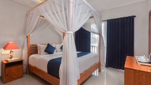 A four-poster bed with white canopy, wooden headboard, and blue bedding. - Ning Villa Ubud by GenuineHost (Ubud)
