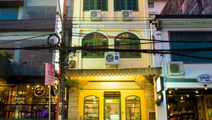 A two-story building with a ground-floor restaurant and upper-floor residential units. - The Neighbors Hostel - Adults Only (Phuket)