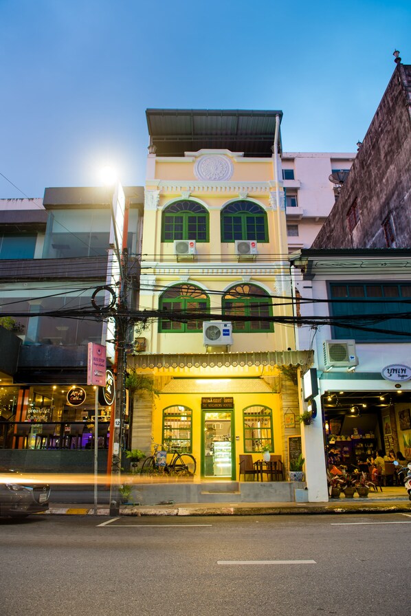 A two-story building with a ground-floor restaurant and upper-floor residential units.