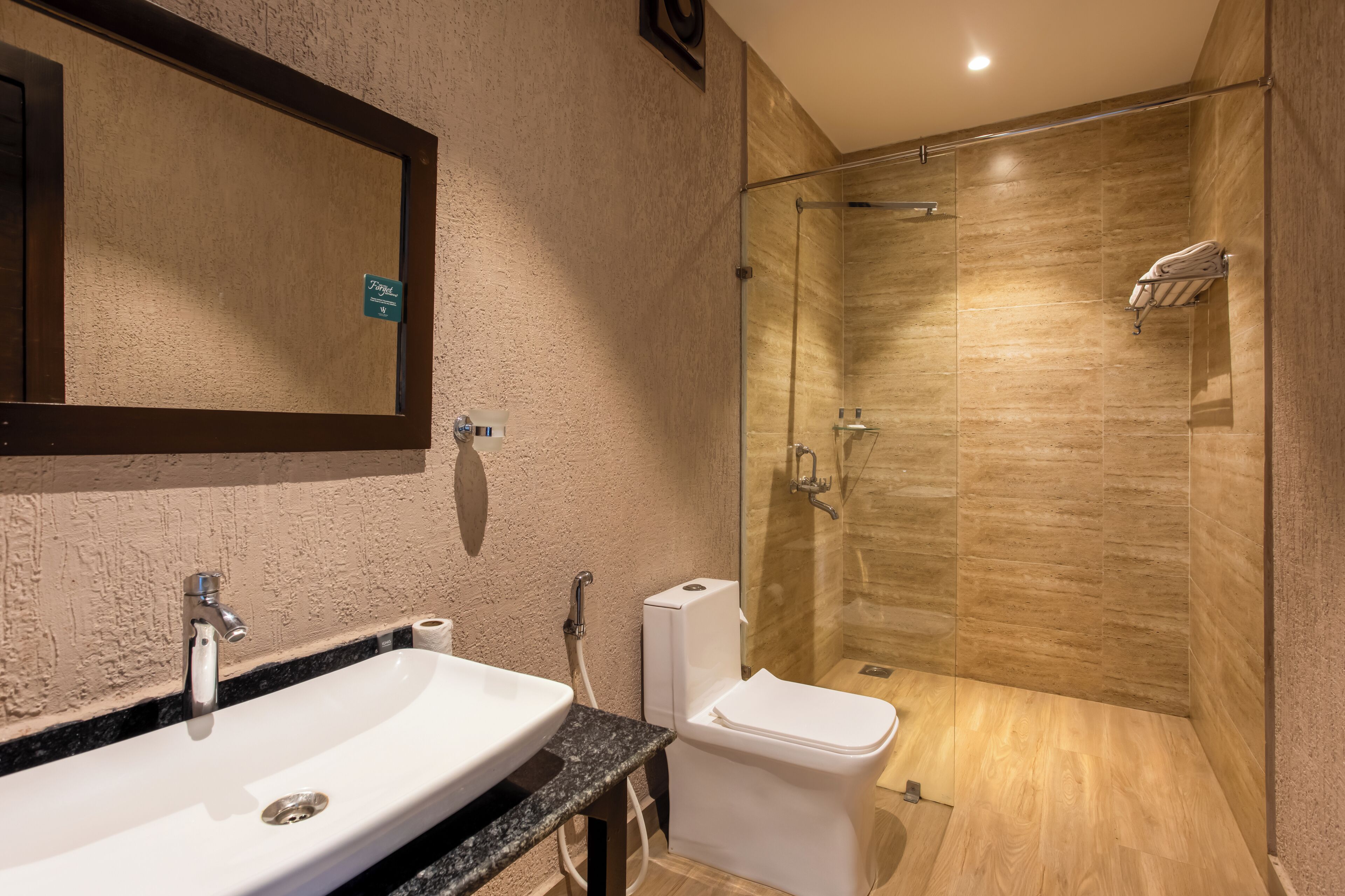 A bathroom with a sink, toilet, and glass-enclosed shower.