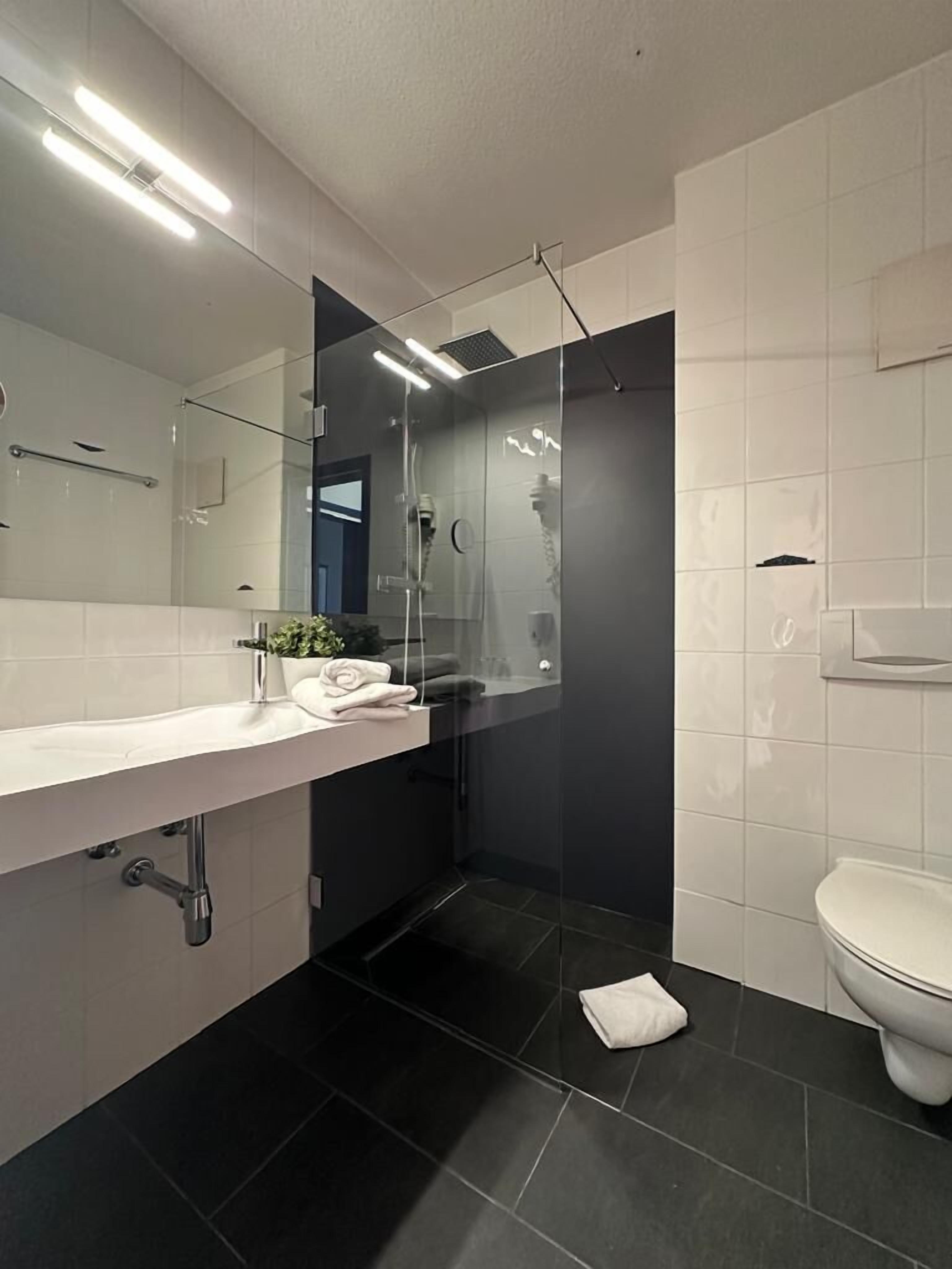 Tweepersoonskamer | Badkamer | Een douche, handdoeken