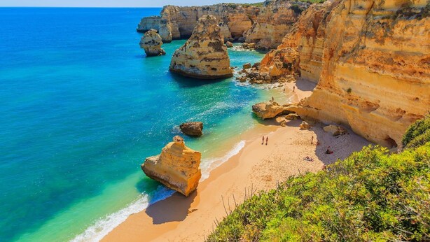A coastal landscape with cliffs, clear turquoise waters, and a sandy beach. - C06 - Porto do Mos 3 bed Townhouse by DreamAlgarve (Lagos)
