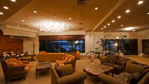 A spacious lobby with a large sofa, multiple armchairs, and a chandelier. - Hotel Hana (Shima)