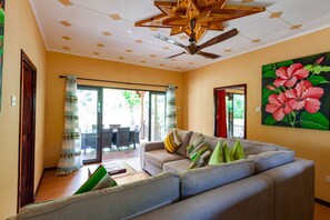 Deluxe Bungalow, 2 Bedrooms | Living room | Plasma TV, fireplace