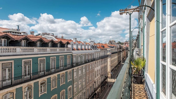 Una hilera de edificios históricos con tejados rojos y balcones.
