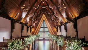 A wooden church interior with pews and floral arrangements. - Le Grand Karuizawa Hotel&Resort (Karuizawa)