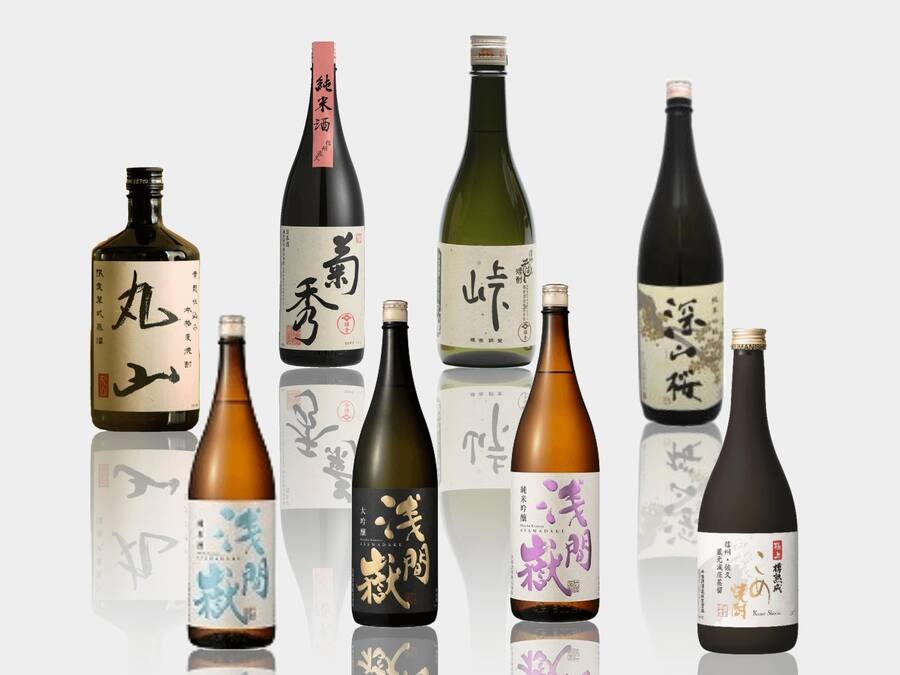A collection of bottles with Japanese labels, likely containing sake or similar beverages.