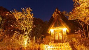 A small stone building with a steep roof, surrounded by trees and a path lined with lanterns. - Le Grand Karuizawa Hotel&Resort (Karuizawa)