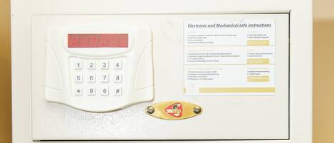 Un microondas con pantalla digital y una hoja de instrucciones de seguridad.