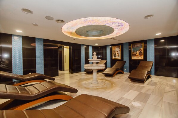 A spa area with massage chairs, a central fountain, and a patterned ceiling. - JRW Welmond Hotel & Casino Batumi (Batumi)