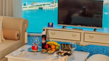 Executive Suite | Living area | 34-inch flat-screen TV with cable channels, TV