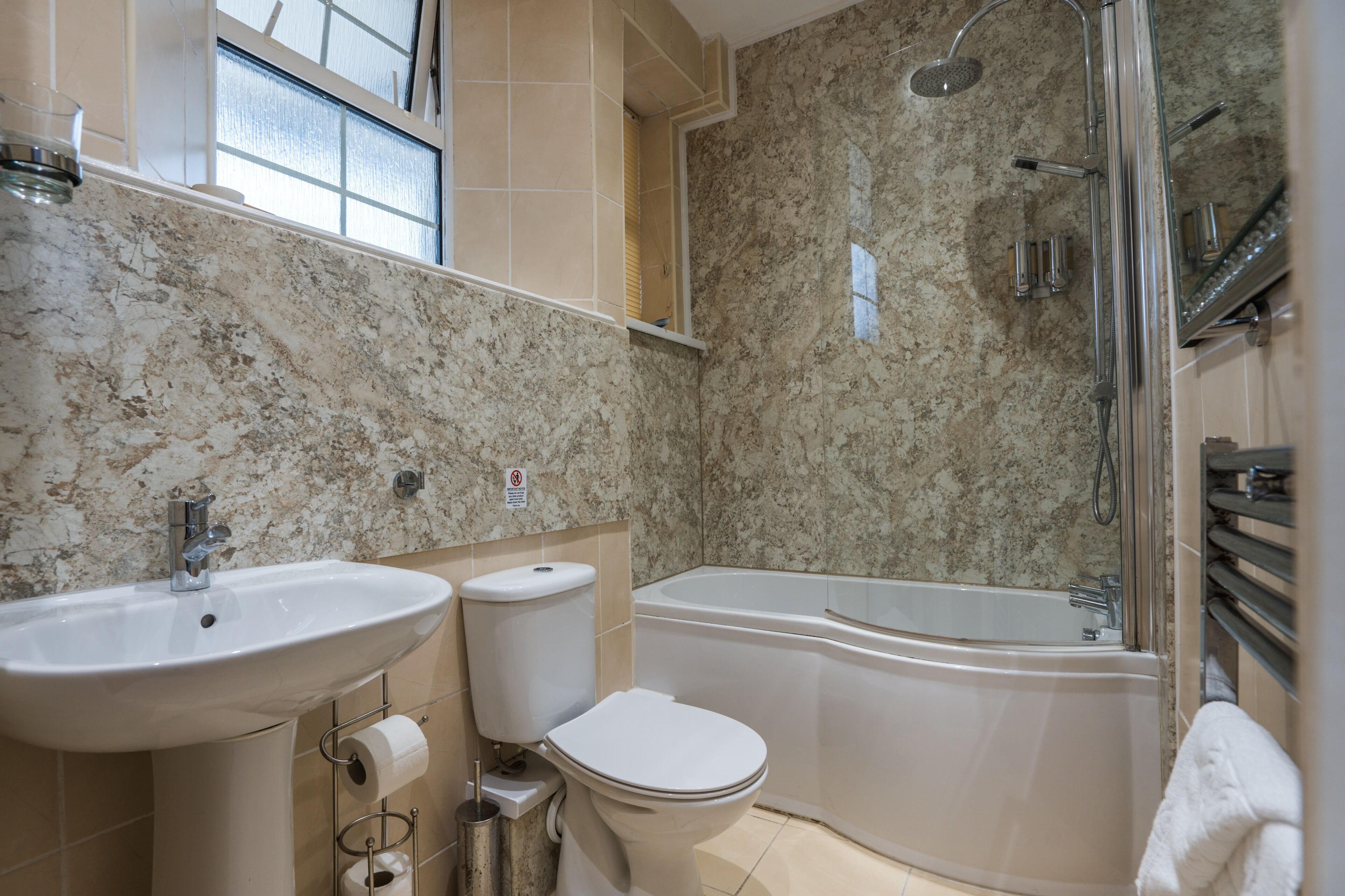 A bathroom with a sink, toilet, and bathtub.