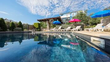 Seasonal outdoor pool, open 9:00 AM to 10:00 PM, pool umbrellas