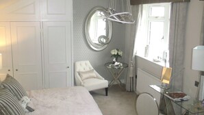A bedroom with a bed, a chair, a desk, and a window. - The Dog at Peover (Knutsford)