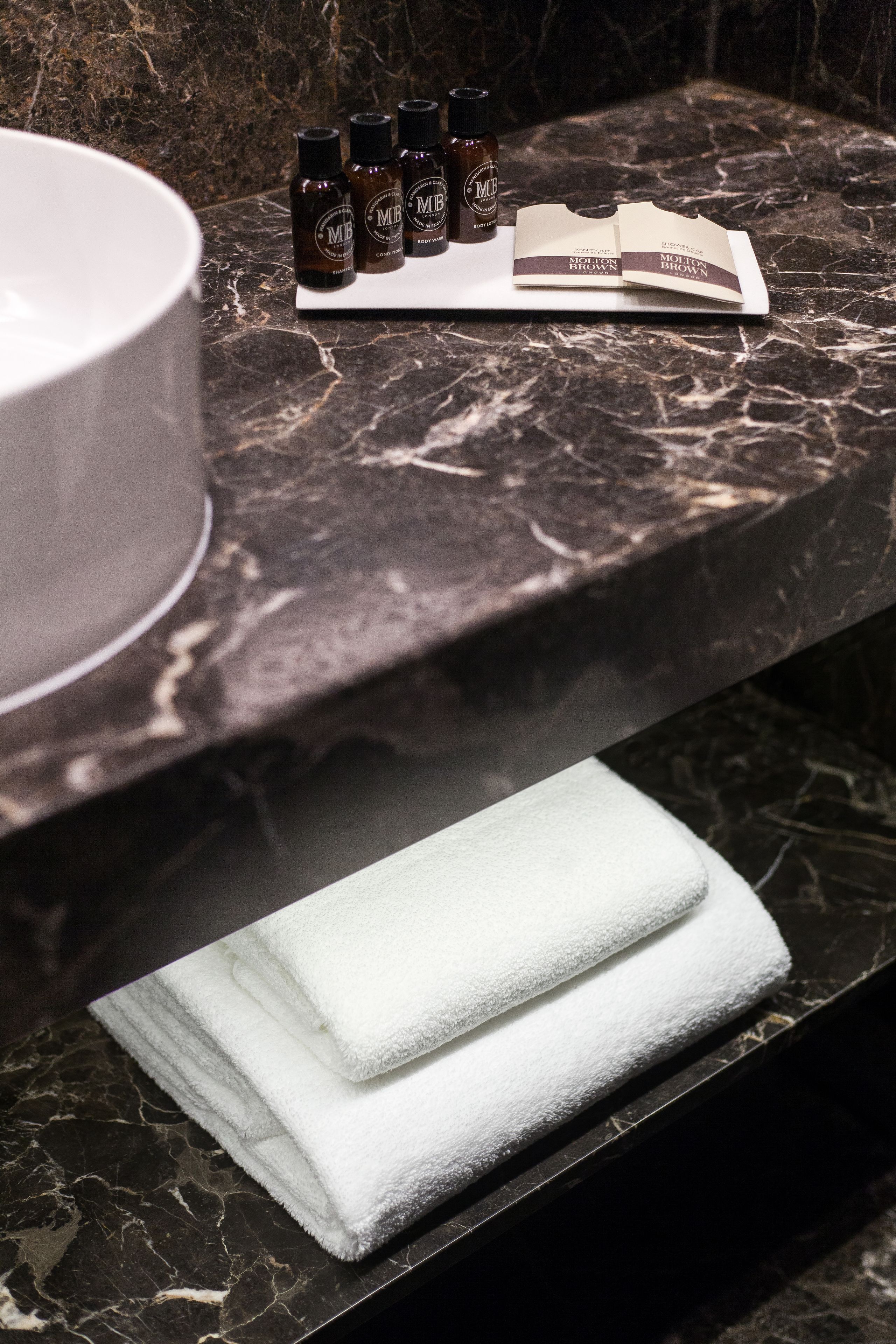 deluxe room | bathroom | designer toiletries, hair dryer, slippers, towels