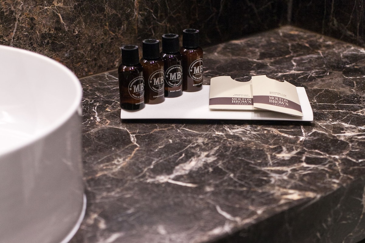 deluxe room | bathroom | designer toiletries, hair dryer, slippers, towels