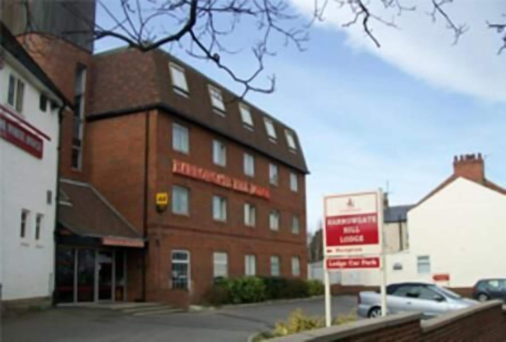 A building with a sign for "Leisure Village Lodge" and a sign for "Leisure Village Park."