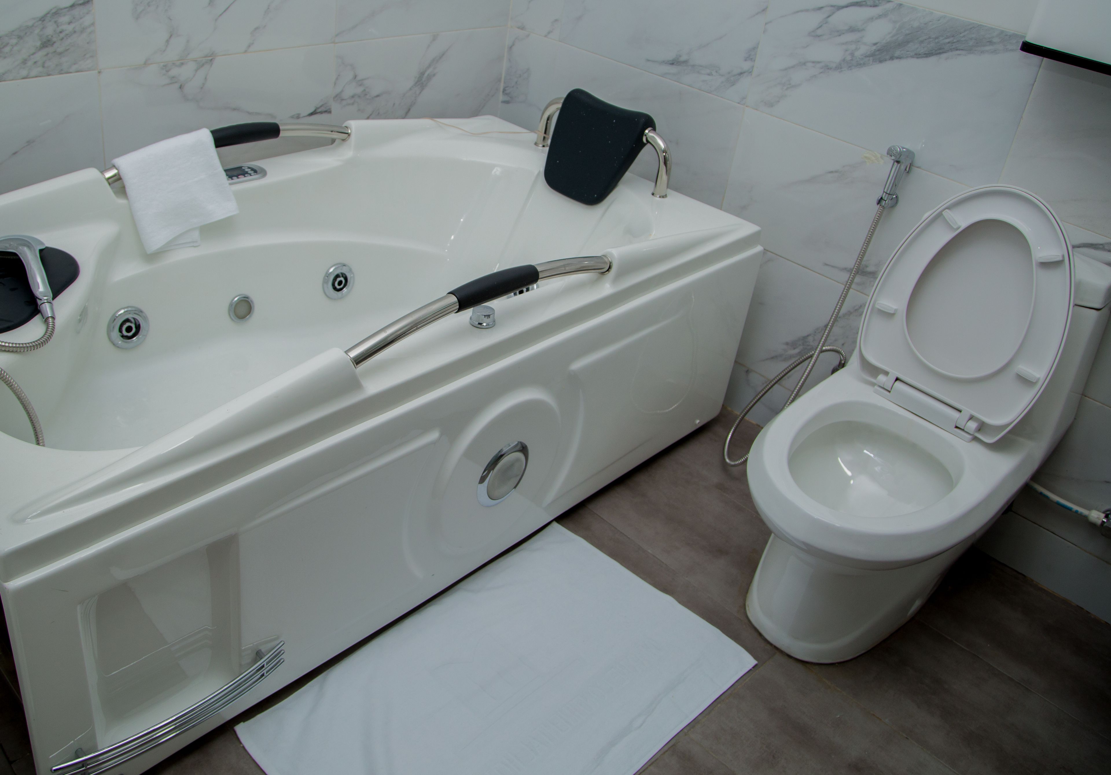 A bathroom with a bathtub, toilet, and a shower.