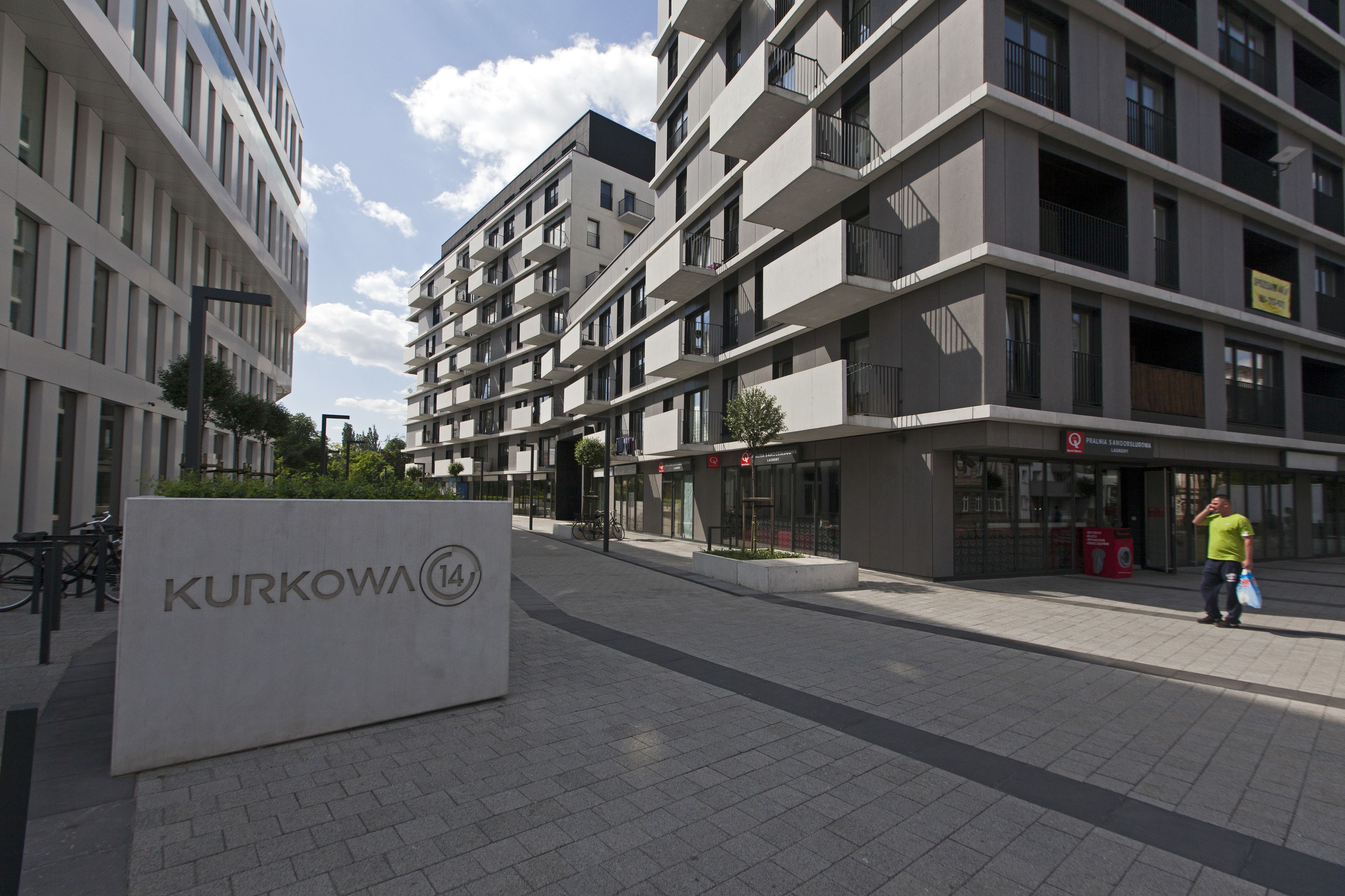 A modern building with a sign reading "KURKOWA 14".