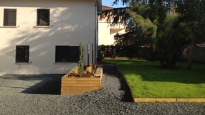 A residential building with a tiled roof, a gravel driveway, and a well-maintained lawn. - Demeure et Dependance (Tassin-la-Demi-Lune)