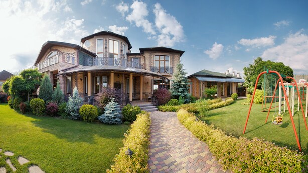 A large, two-story house with a covered porch and a brick exterior. - Premium Village Residence (Hora)