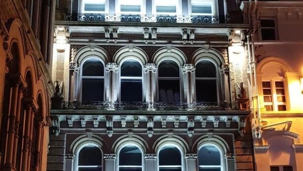 A historic building with a Starbucks Coffee store on the ground floor.