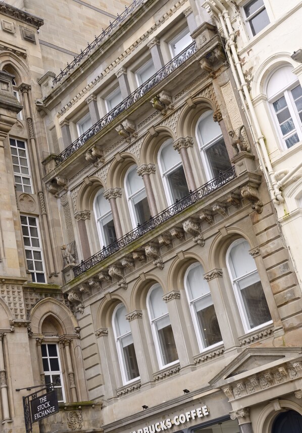 A historic building with ornate architectural details, including arched windows and decorative stonework.