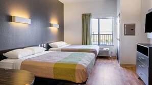 A hotel room with two beds, a TV, a desk, and a window with curtains. - Studio 6 Buda, TX (Buda)