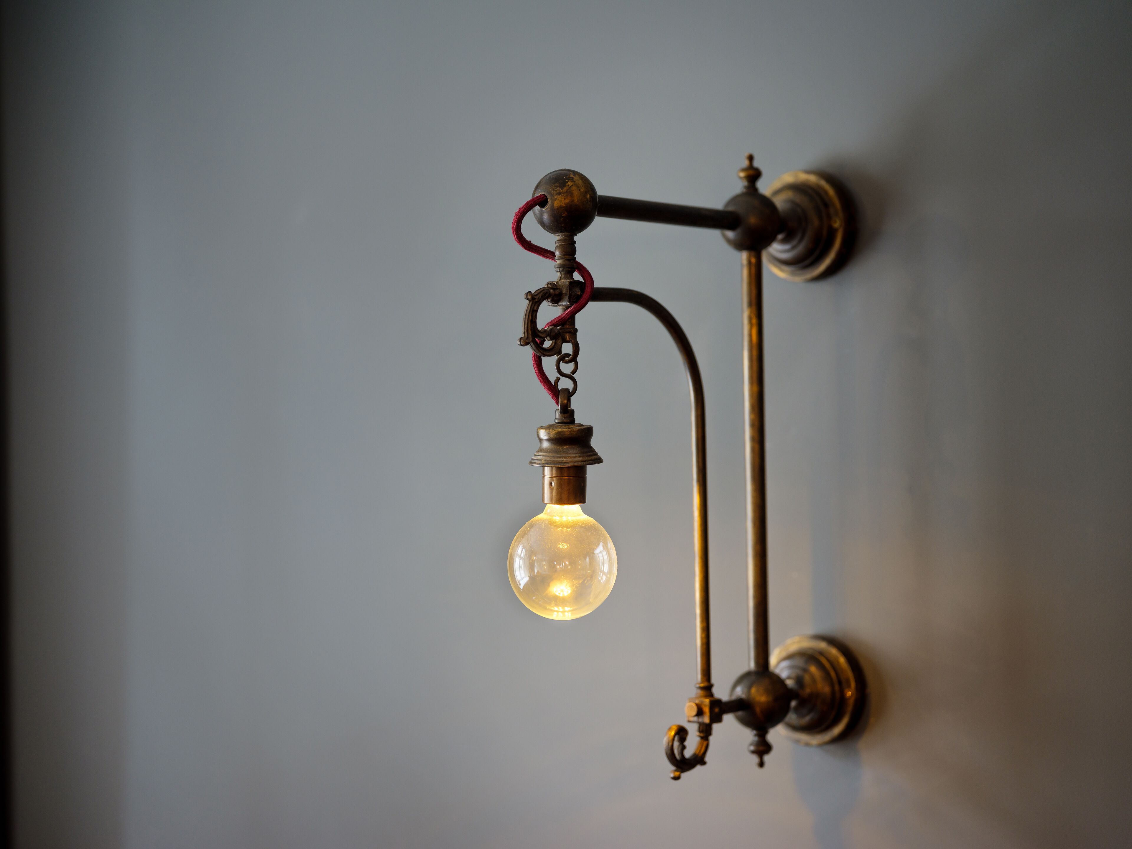 A wall-mounted light fixture with a single bulb.