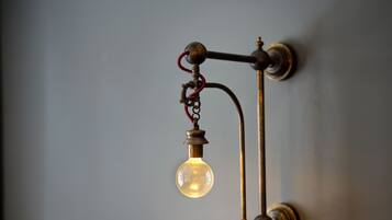 A wall-mounted light fixture with a single bulb.