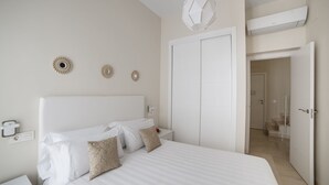 Un dormitorio con una cama grande, un armario y una puerta que da al baño.
