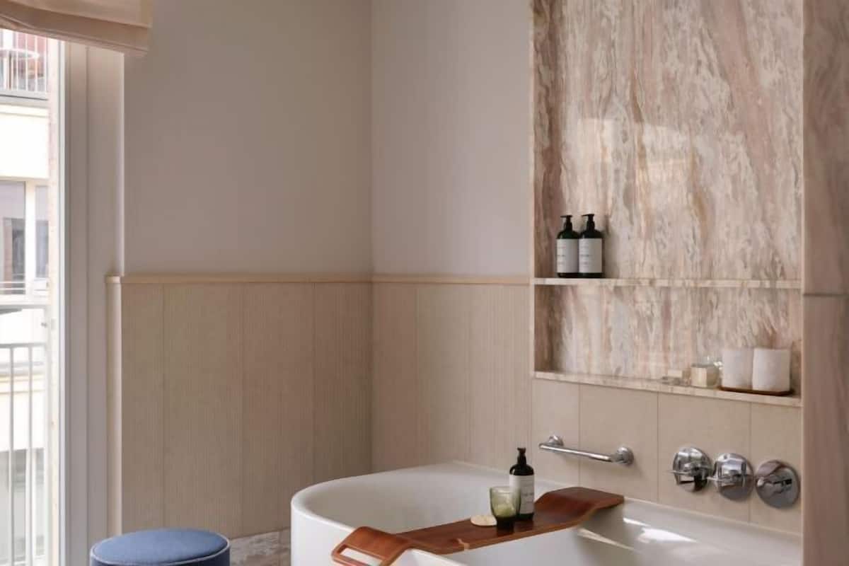 Combined shower/bathtub, designer toiletries, bathrobes, slippers