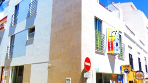 A hotel with a modern facade, a visible entrance, and a sign indicating it is a hotel. - The 17 Hostel (Lagos)