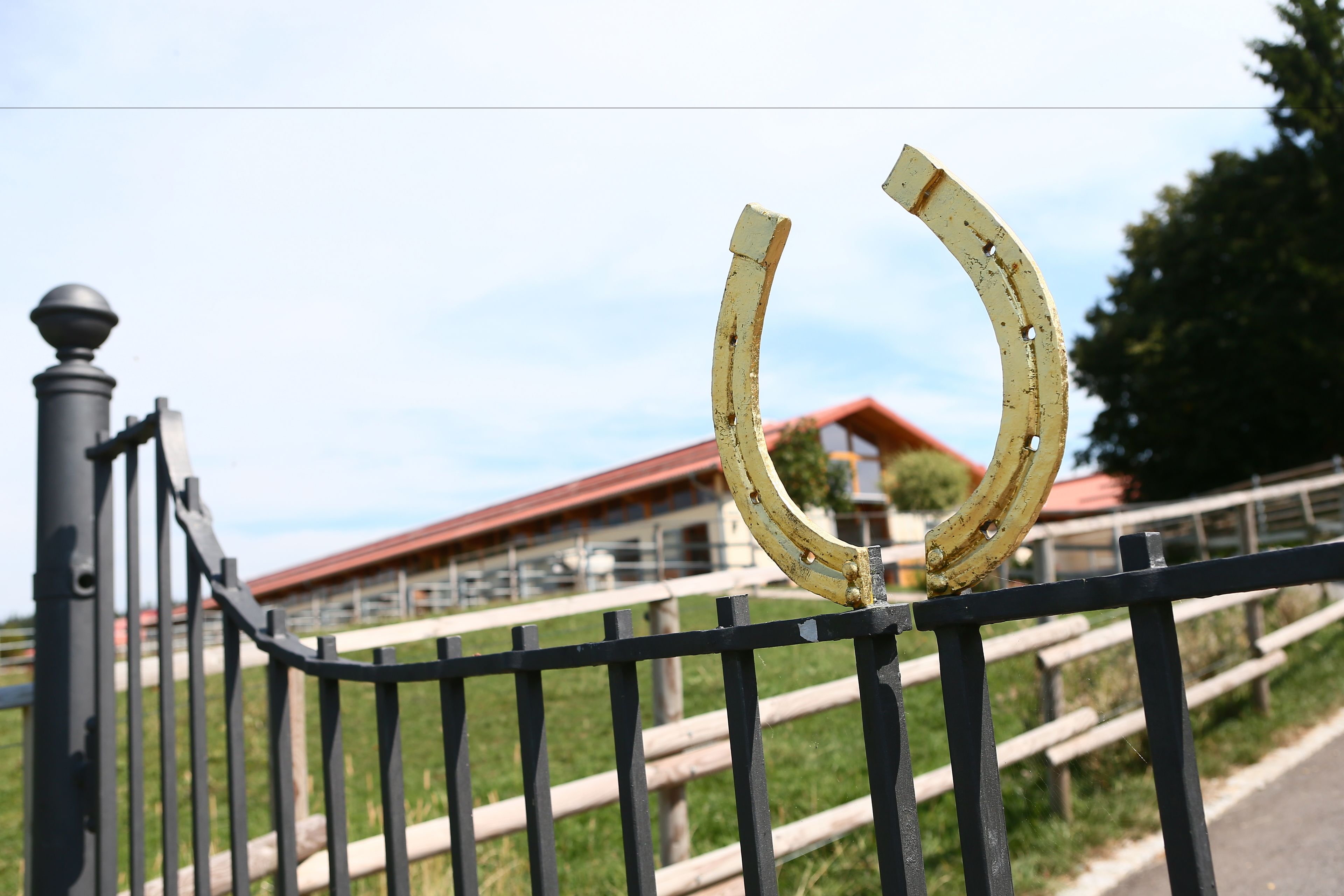A metal fence with a horseshoe-shaped object attached to it.