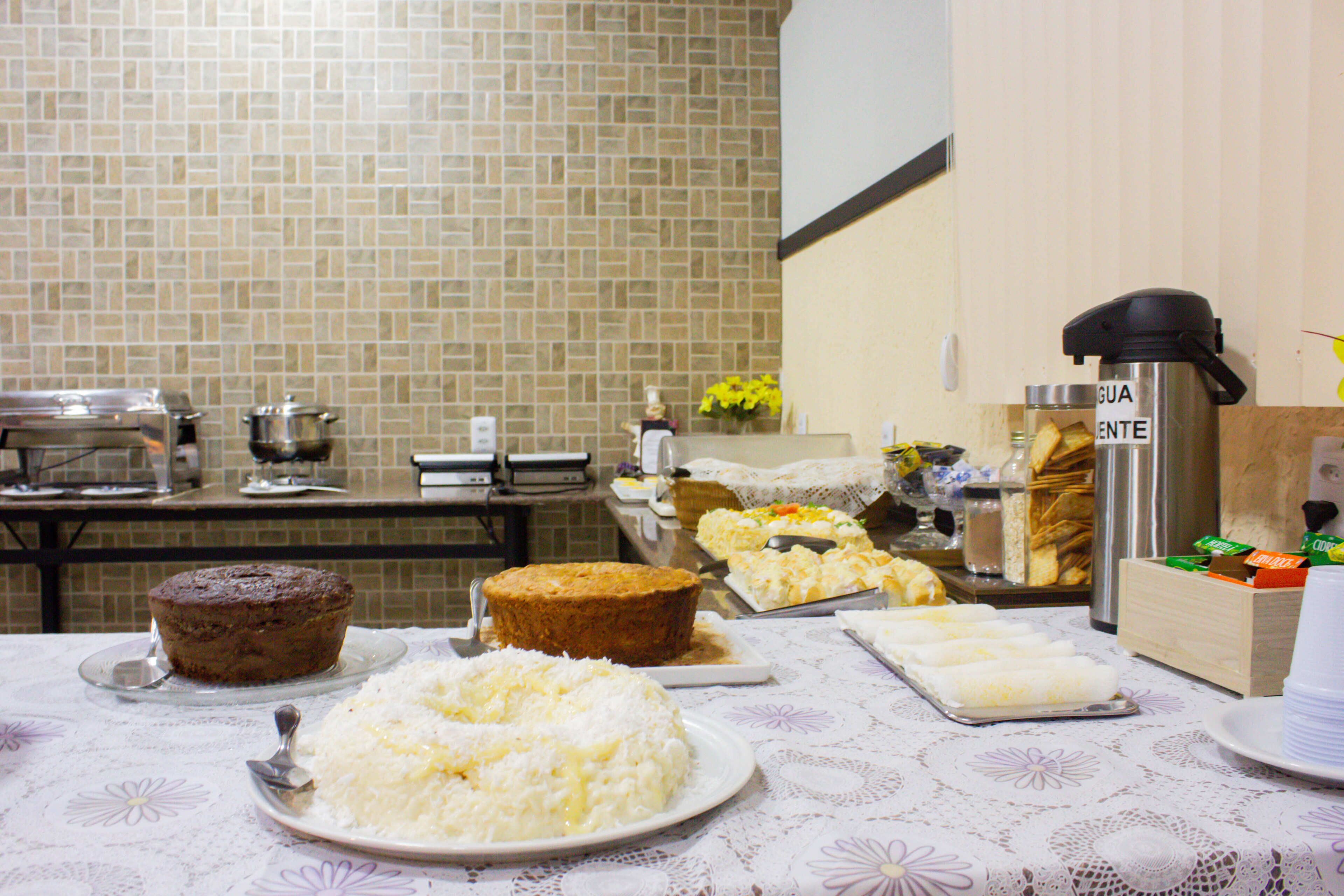 A buffet table with various dishes including a cake, rice, and other food items.