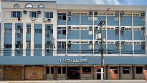Ein mehrstöckiges Hotelgebäude mit Klimaanlagen und einem Schild, auf dem 