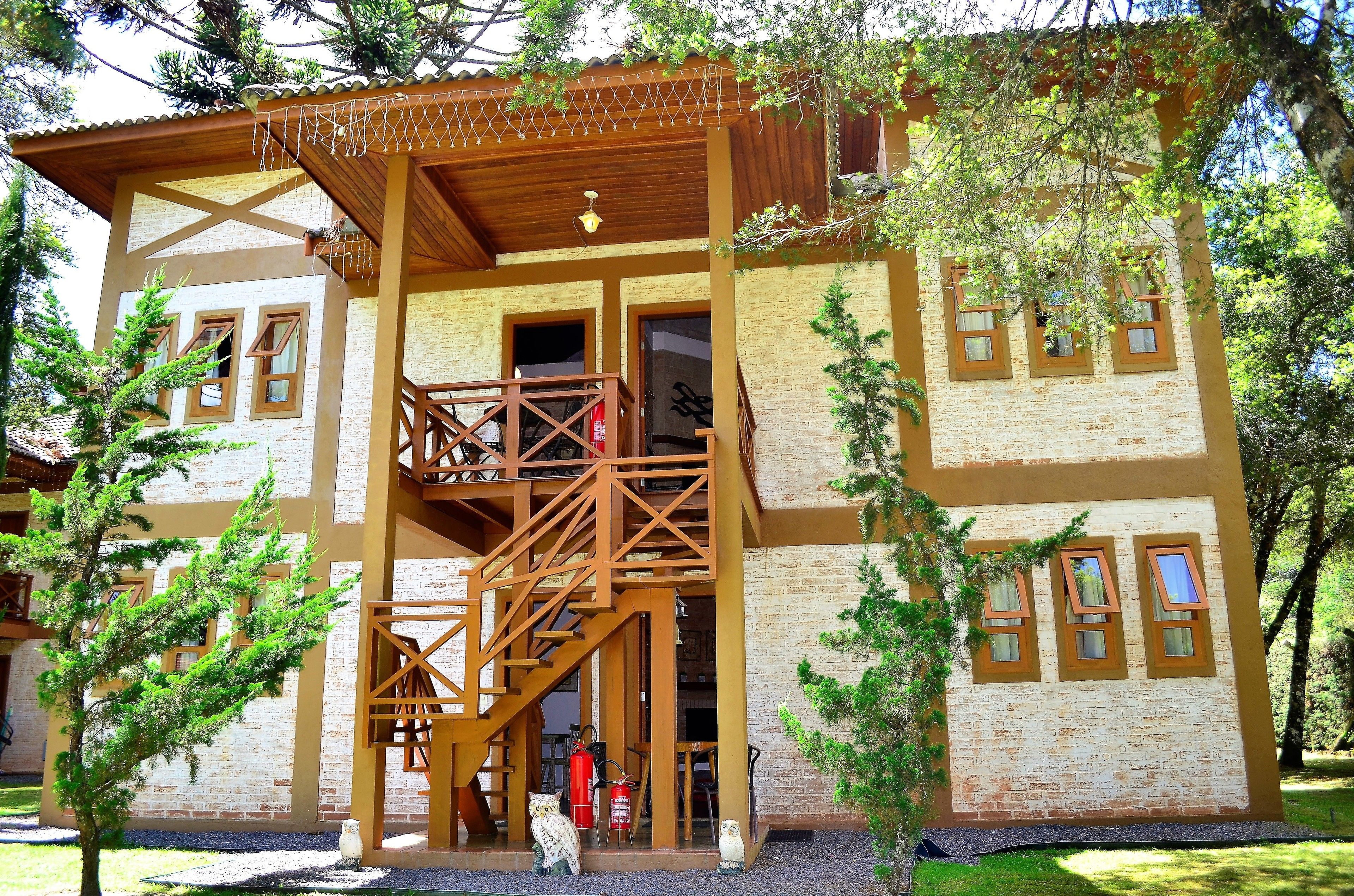 A two-story building with a wooden balcony, a staircase, and a fire extinguisher.