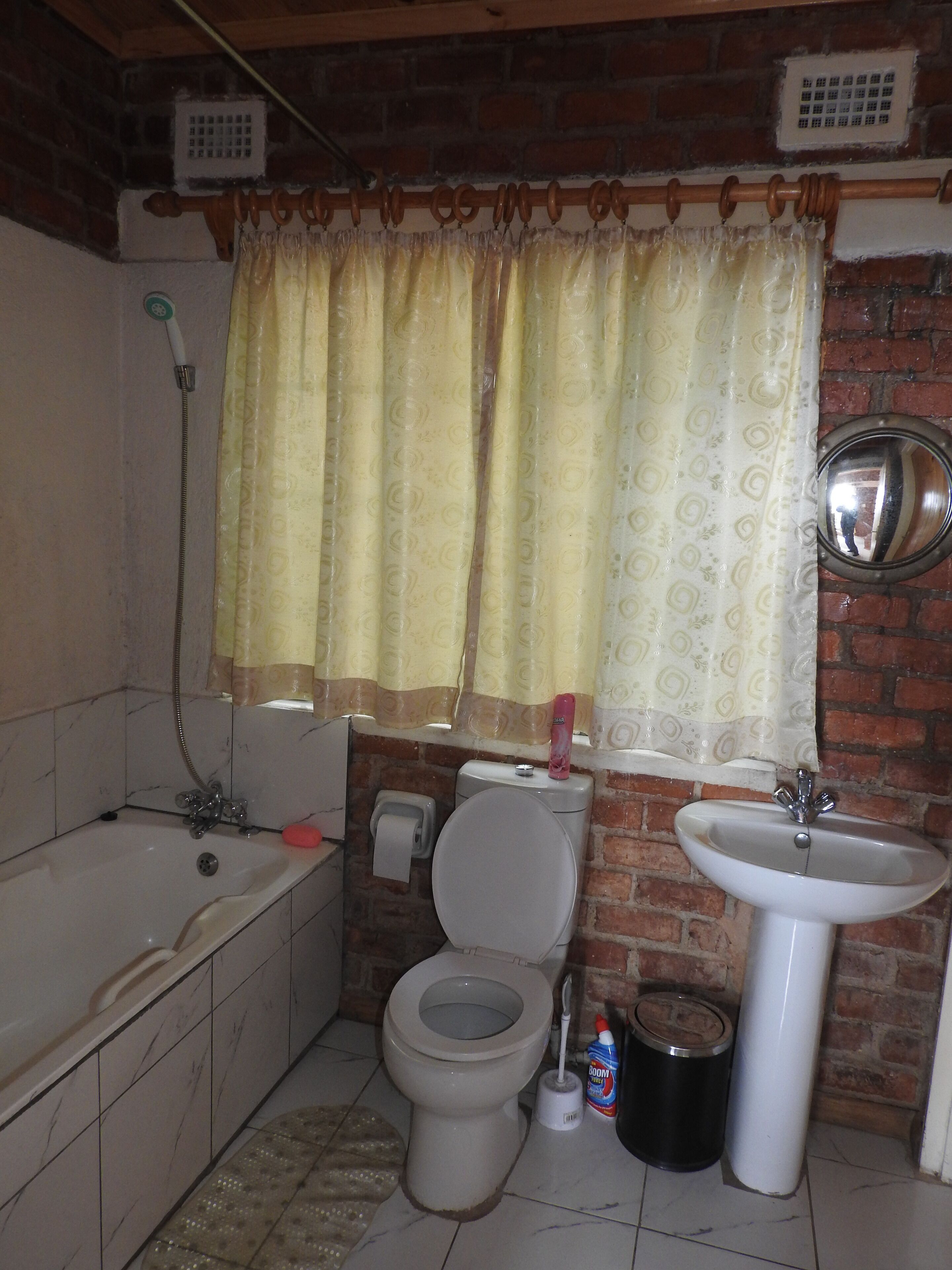 A bathroom with a bathtub, toilet, and sink.