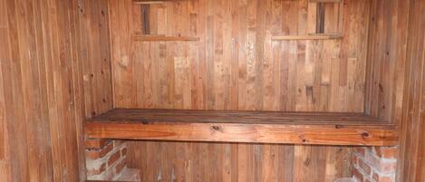 A wooden interior with two wooden benches.