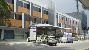 A hotel named 'Kyriad' with a modern design, featuring a covered parking area and multiple floors. - Kyriad Hotel Fatmawati - Jakarta (Jakarta)