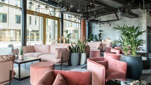 A modern lounge area with plush seating, large windows, and industrial decor. - Quality Hotel The Box (Linkoping)