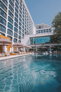 Outdoor pool, a heated pool, open 6:00 AM to 10:00 PM, pool umbrellas at The LINE Austin