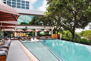 Outdoor pool, a heated pool, open 6:00 AM to 10:00 PM, pool umbrellas - The LINE Austin (Austin)