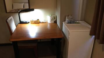 Desk, iron/ironing board, bed sheets