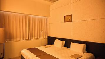 Habitación de hotel con una cama grande, una mesita de noche, una ventana con cortinas y un cuadro colgado en la pared.