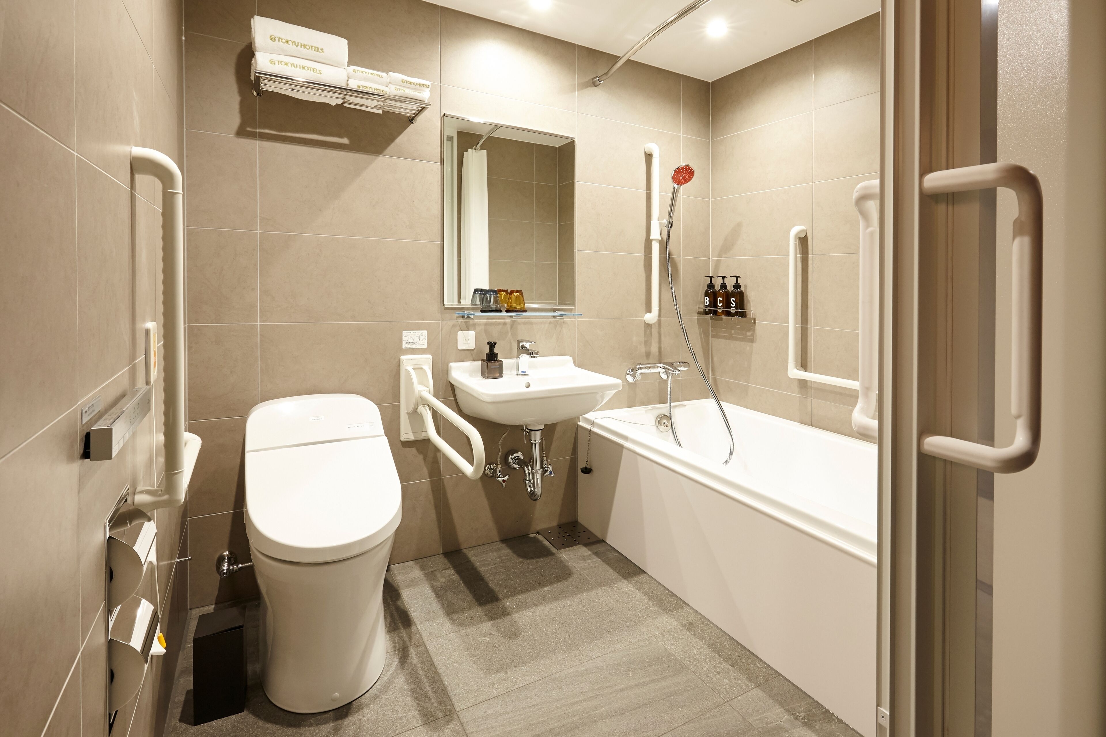 accessible twin room | bathroom | hair dryer, slippers, bidet, towels